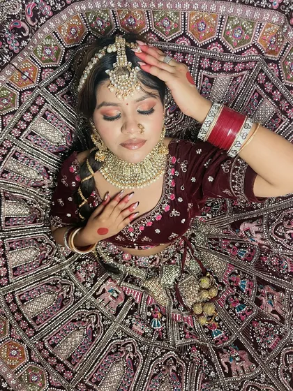 This stunning shot captures the full glory of the bridal lehenga and the complementary makeup. Our students learn to create cohesive looks where every element works in harmony.