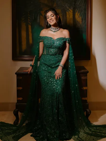 A full view of the reception look, where the makeup perfectly complements the stunning emerald gown. The goal was to create a cohesive, elegant style that is both glamorous for the evening and photographs beautifully from every angle. This is the essence of effortless, head-to-toe radiance.