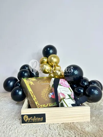 A chic and modern gift hamper styled in black and gold, proving that gift presentation can be as luxurious as the gift itself.
