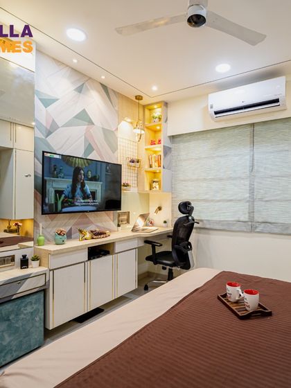 This bedroom shows how to make a minimalist design feel cozy. We combined layered textiles, a plush headboard, and a functional TV and study unit.