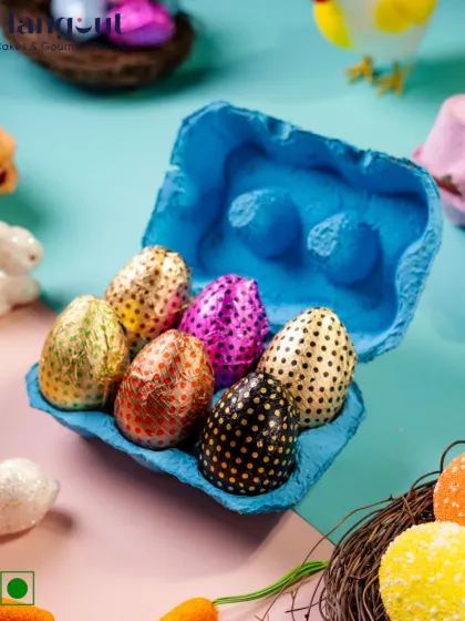 This Half A Dozen Easter Egg Hamper is a simple and delightful treat. It contains six rich, 100% vegetarian chocolate eggs in a quirky egg carton, perfect for Easter egg hunts or as a small gift.