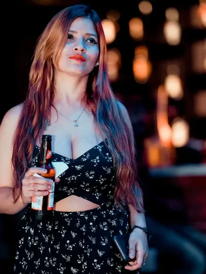 A guest enjoying a drink and taking in the vibrant nightlife scene.