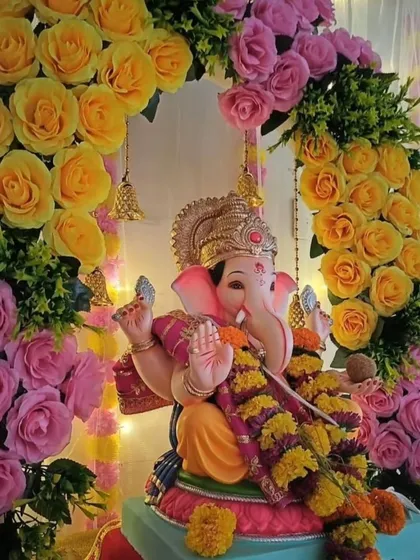 We also create beautiful setups for sacred occasions. This Ganesh Chaturthi decoration features a stunning arch of fresh yellow and pink roses, creating a divine and auspicious focal point for your office or home pooja.