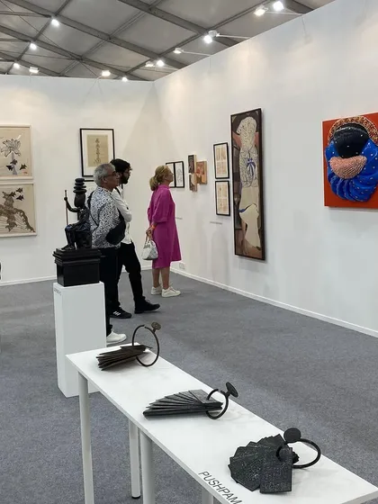 Visitors admiring the sculptures and paintings in our curated presentation.