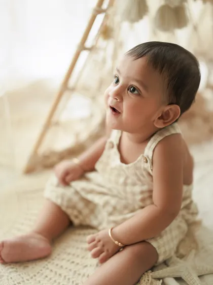 The sparkling innocence in those tiny, shining eyes. A close-up portrait is a must-have during a first birthday session to capture their sweet expressions.