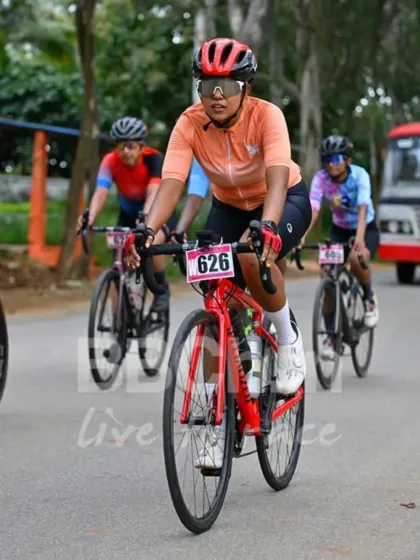 A female cyclist leads the pack, setting the pace for the group. The strength and endurance of our women racers are truly inspiring.