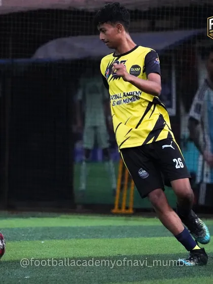 A player running with the ball, demonstrating speed and control during a training drill.