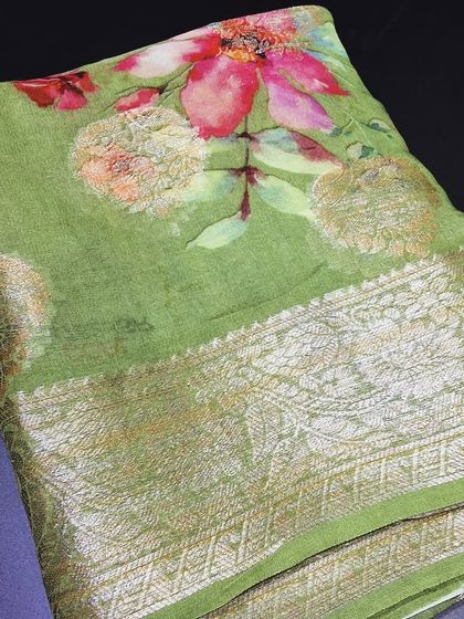 A beautiful green viscose saree with a delicate floral print and a rich zari border. The combination of modern and traditional elements makes this saree truly special.