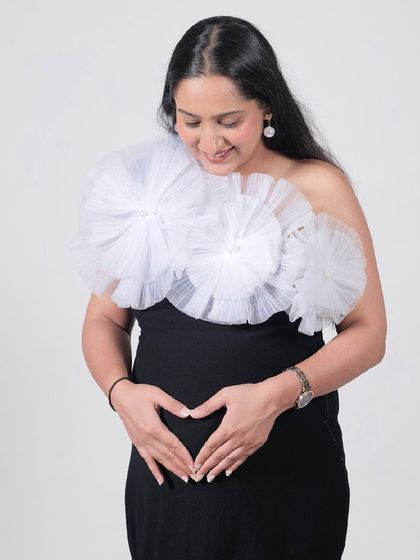 Our Veneccia gown is a classic black dress with a twist. The detachable white tulle flowers add a touch of modern, artistic flair.