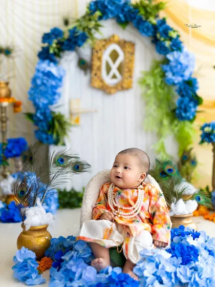 This little one looks serene in his festive outfit, seated in front of a decorative backdrop for his Janmashtami mini session. I provide all the costumes and props.