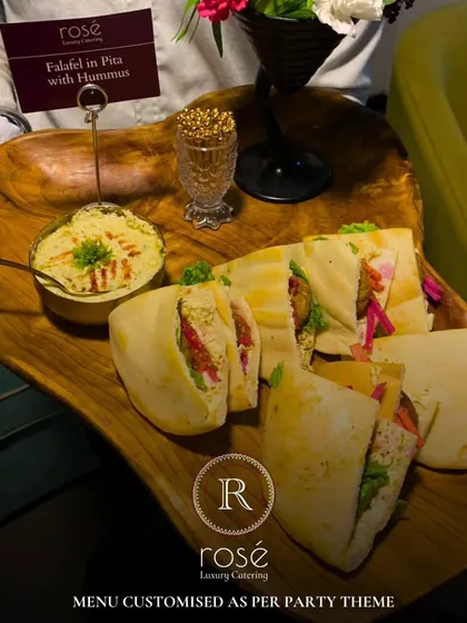 A platter of our Falafel in Pita with Hummus, customized for a house party theme. We excel at creating extraordinary dining experiences by transforming imaginative dreams into delectable art.