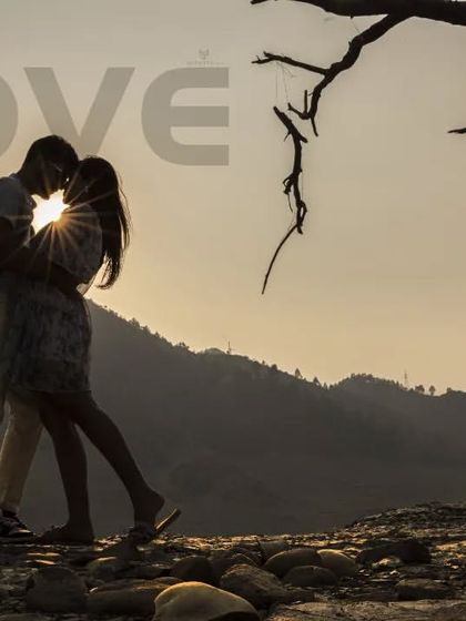A romantic silhouette of a couple kissing against the sunset, with the word "Love" overlaid. This is a beautiful and artistic way to capture a special moment.