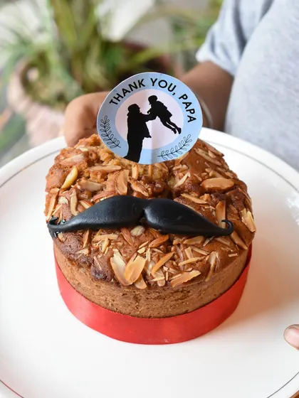 For the health-conscious dads, I created this special whole wheat jaggery cake. Topped with crunchy almonds and a cute mustache, it's a thoughtful and delicious way to celebrate Father's Day without the guilt.