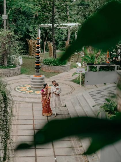 This wide-angle portrait shows the family within the beautiful, sprawling gardens of the event venue. It's a great way to capture not just the people, but also the scale and atmosphere of the day.