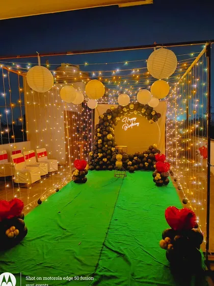 A wide shot of the terrace decoration, showing the seating area in the background. This setup is perfect for hosting a small, private celebration under the stars.
