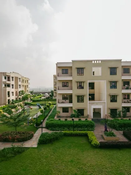 This image of the JSW Vidyanagar township showcases how clustered housing blocks can create large, shared green spaces. This planning strategy promotes community interaction and provides residents with beautiful, functional landscapes.