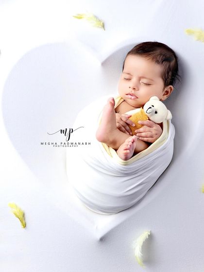 A top-down view of the baby and bear, creating a perfect heart-shaped frame.