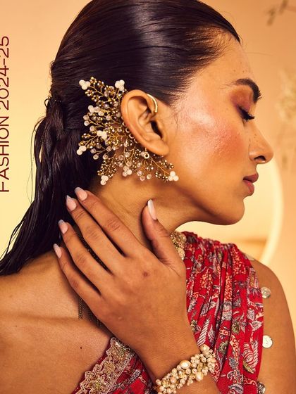 Don't miss the drama this wedding season. A model wears our statement golden earcuff for a bold festive look.