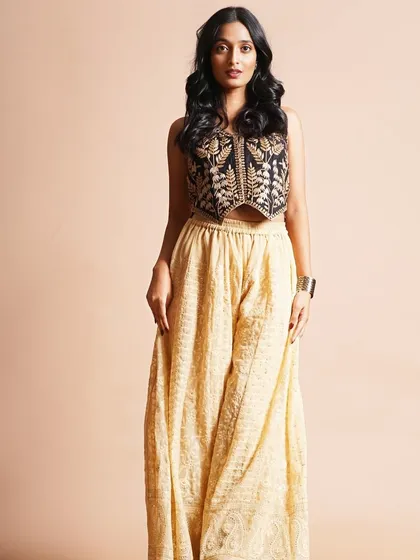 This look showcases a chic, Indo-Western style. I created a clean, sophisticated makeup look with defined eyes and soft waves in the hair to complement the embroidered vest and palazzo pants.