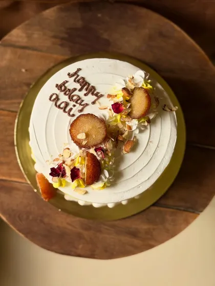A birthday cake for 'Aai' (mom) in one of my most-loved Indian fusion flavors: Gulabjamun Rabdi. I top it with actual gulab jamuns, chopped nuts, and edible flower petals for a truly special treat.