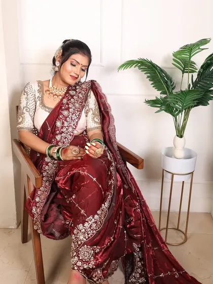 The combination of the maroon velvet and the embroidered cream blouse creates a look of pure elegance.