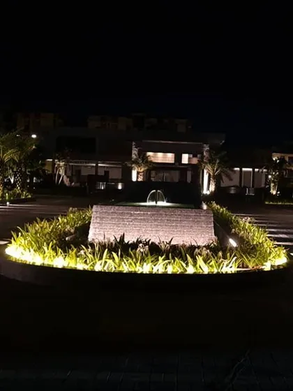At the entrance to the Silver Oak housing project, I combined landscape and architectural lighting to create a grand sense of arrival. Uplights highlight the palm trees while focused beams illuminate the central water feature and pathways.