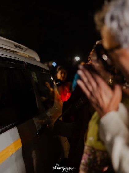 The bride smiling at her father from the car, a bittersweet farewell.