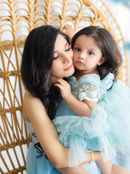 A tender embrace between a mother and her little girl. The soft lighting and beautiful outfits make this an incredibly sweet portrait.