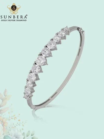 A classic silver tennis-style kada bracelet. The continuous line of sparkling stones makes this a piece of timeless luxury that can elevate any outfit.