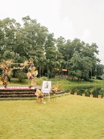 The full proposal setup in daylight, showing the stage, a memory cart with photos, and the stunning natural backdrop of Karjat.