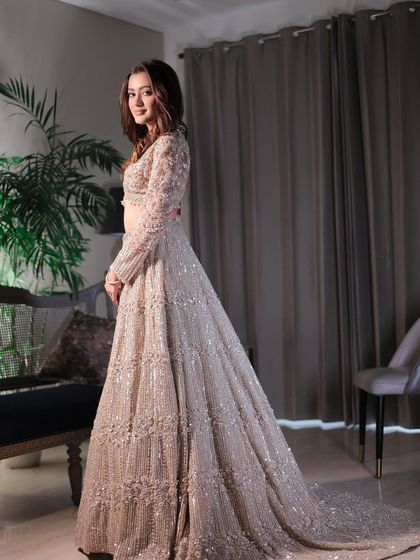 The full view of this understated yet elegant look. The shimmering lehenga and minimalist makeup create a sheer, natural radiance.