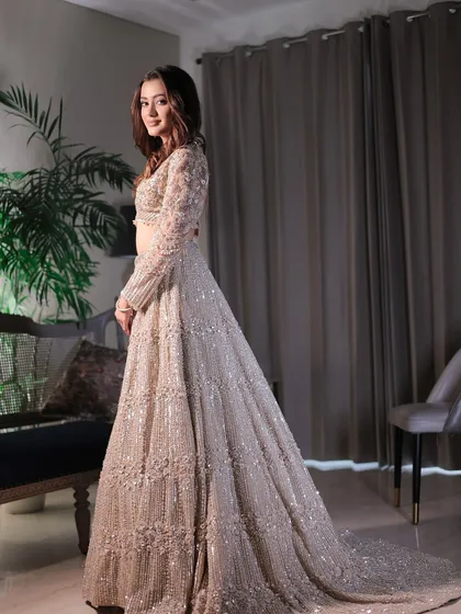 The full view of this understated yet elegant look. The shimmering lehenga and minimalist makeup create a sheer, natural radiance.