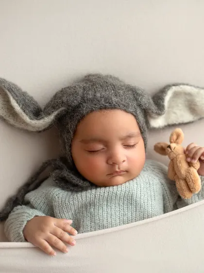 The same adorable bunny hat pose. He looks so peaceful and content while dreaming.