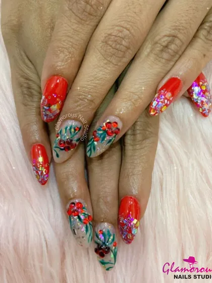This festive set is perfect for celebrations. It combines a vibrant red base with chunky, multi-colored glitter. The accent nails feature intricate, hand-painted red flowers with green leaves, creating a look that's full of life and color.