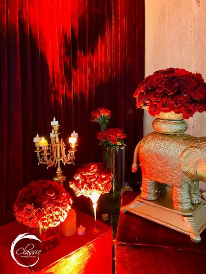 A close-up of the decor, showing how I layered elements like a golden elephant statue, candelabras, and deep red roses to build a rich, textured, and culturally resonant theme.