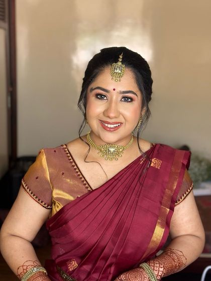 A happy, smiling portrait, her makeup looking fresh and enhancing her joyful expression.