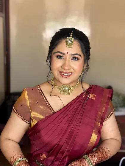 A happy, smiling portrait, her makeup looking fresh and enhancing her joyful expression.