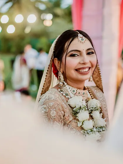 A beautiful, happy close-up during the ceremony. Her smile is infectious, and her glowing makeup enhances her natural radiance.
