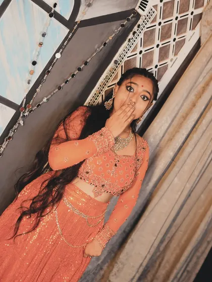 A playful, shy pose from the same photoshoot. It's all about conveying different moods.