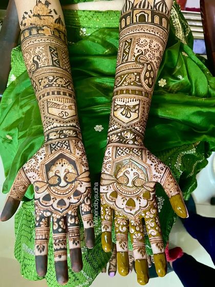 A detailed view of Divya's bridal mehendi, highlighting the couple's initials 'S' and 'D' hidden within the design.