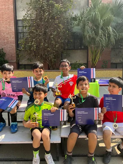 The runners-up team, DYFA Neons, proudly displaying their medals and certificates. We celebrate effort and participation too.