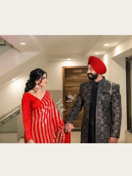 A simple yet powerful shot of Vanaja and Angad holding hands and looking at each other, with the words 'You & Me' emphasizing their connection.