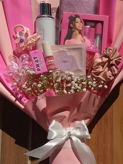 Sometimes a gift needs to be both a hamper and a bouquet. This stunning arrangement combines beauty essentials, skincare products, and sweet treats, all wrapped up in a beautiful pink bouquet style for a truly glamorous surprise.