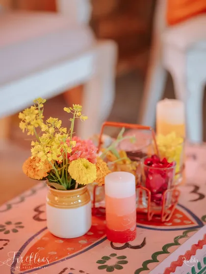 A small table centerpiece with fresh flowers and colorful candles. Even the smallest corners were filled with details that matched the joyful theme.