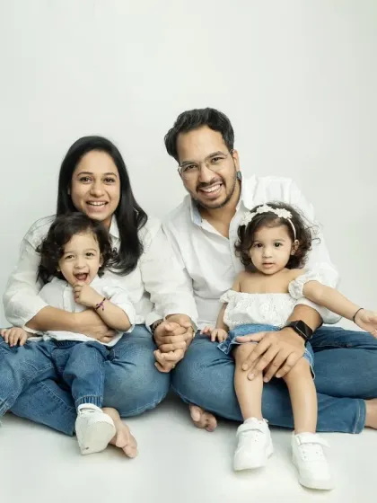 A lovely family photo with everyone holding hands, a symbol of their strong family bond.