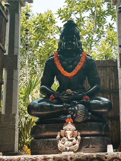 The statue of Hanuman, the embodiment of devotion and selfless service, sits peacefully in our garden. His presence is a constant inspiration to live our yoga with heart and dedication.
