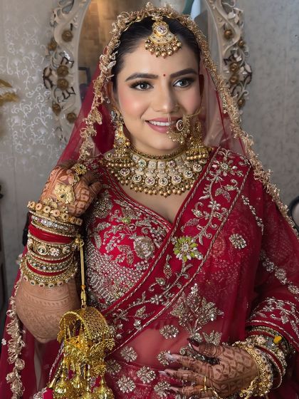 This bride is glowing. Her smile says it all. The makeup is fresh and radiant, perfect for her special day.