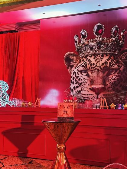 The stage backdrop featured the crowned Cartier leopard, ensuring the brand's identity was front and center. The design blended powerful brand imagery with opulent event decor for maximum impact.
