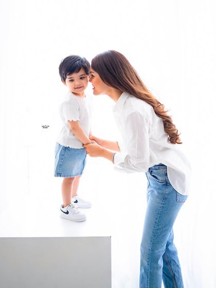 A tender moment between a mother and her son, sharing a little secret.