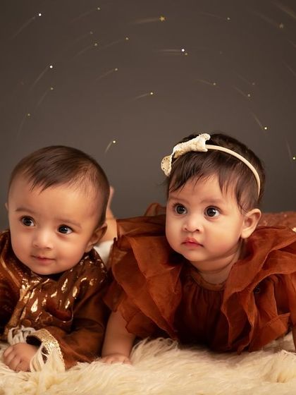 Two little "cou-twins" looking on with curiosity. Born on the same day, these cousins share a unique bond that I was honored to capture during their first photoshoot together.